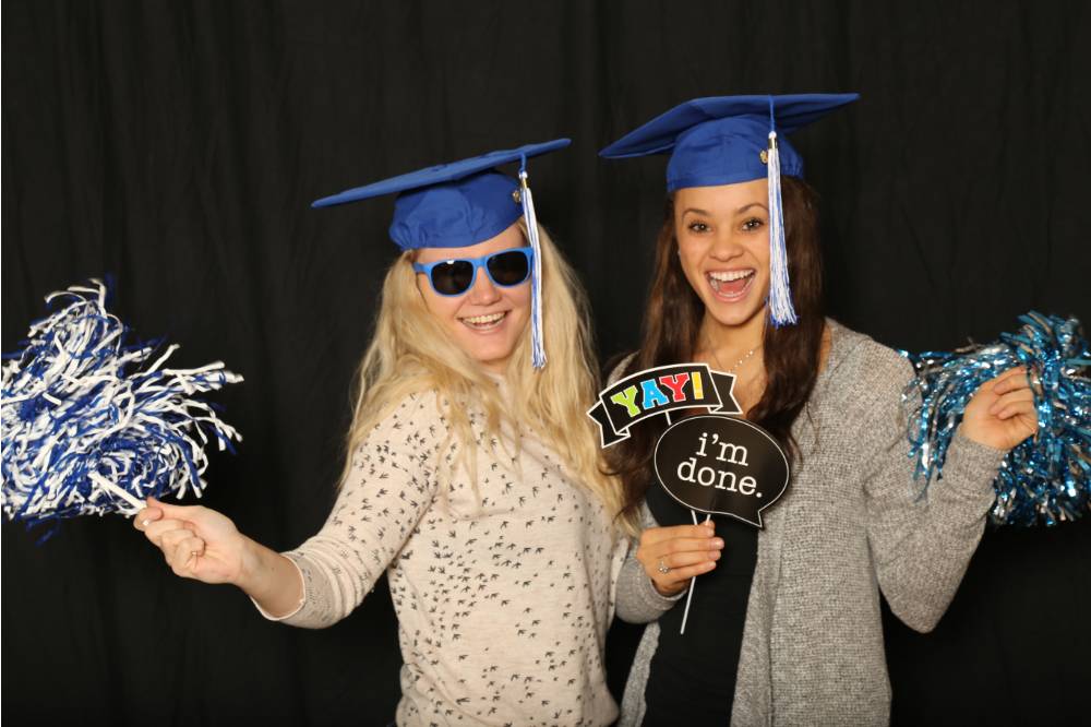 two friends in graduation caps taking a picture